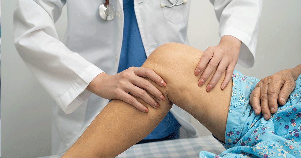 Doctor examining an elderly woman’s joints during a consultation, illustrating arthritis assessment and management in a clinical setting.