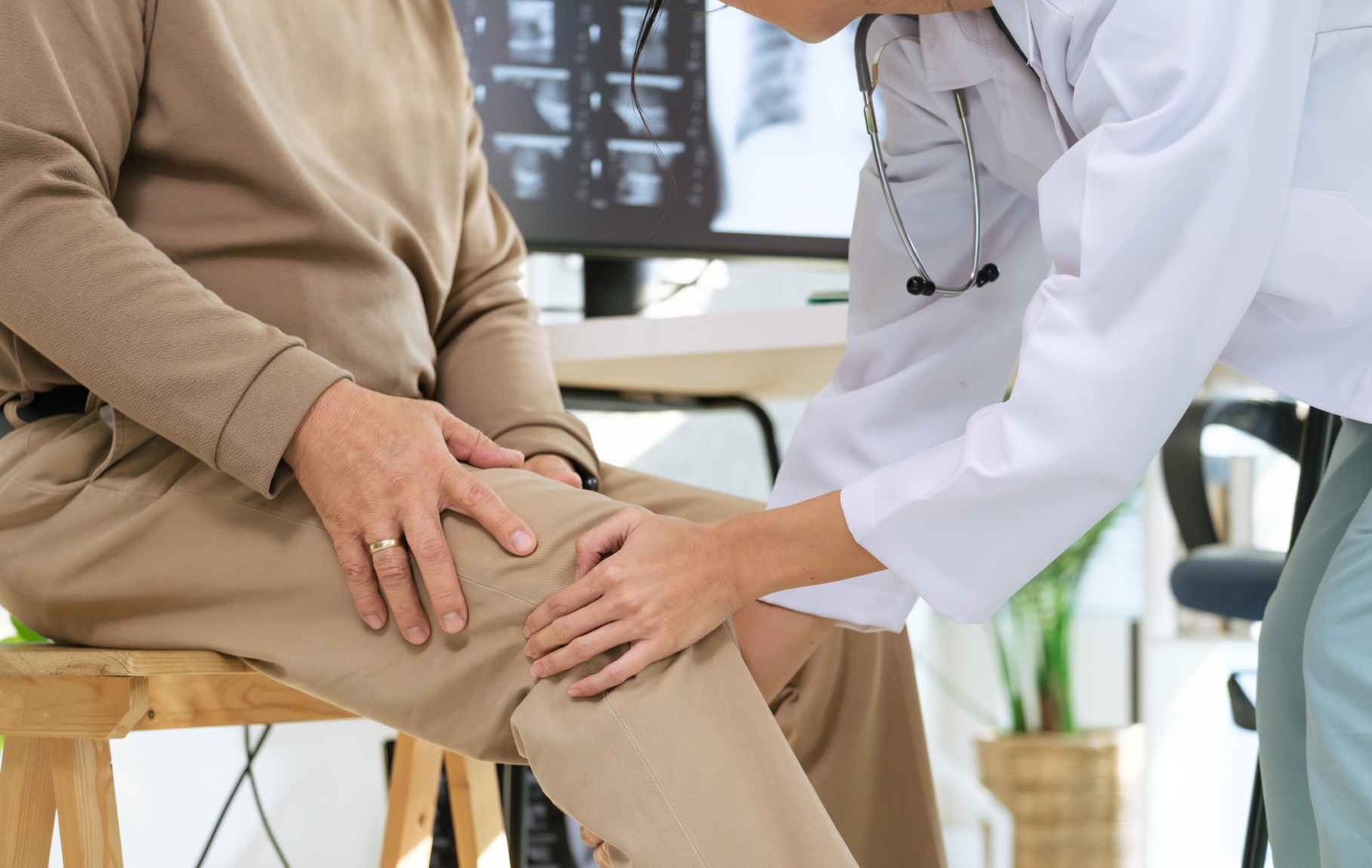Rheumatologist examining patient for cause of joint pain