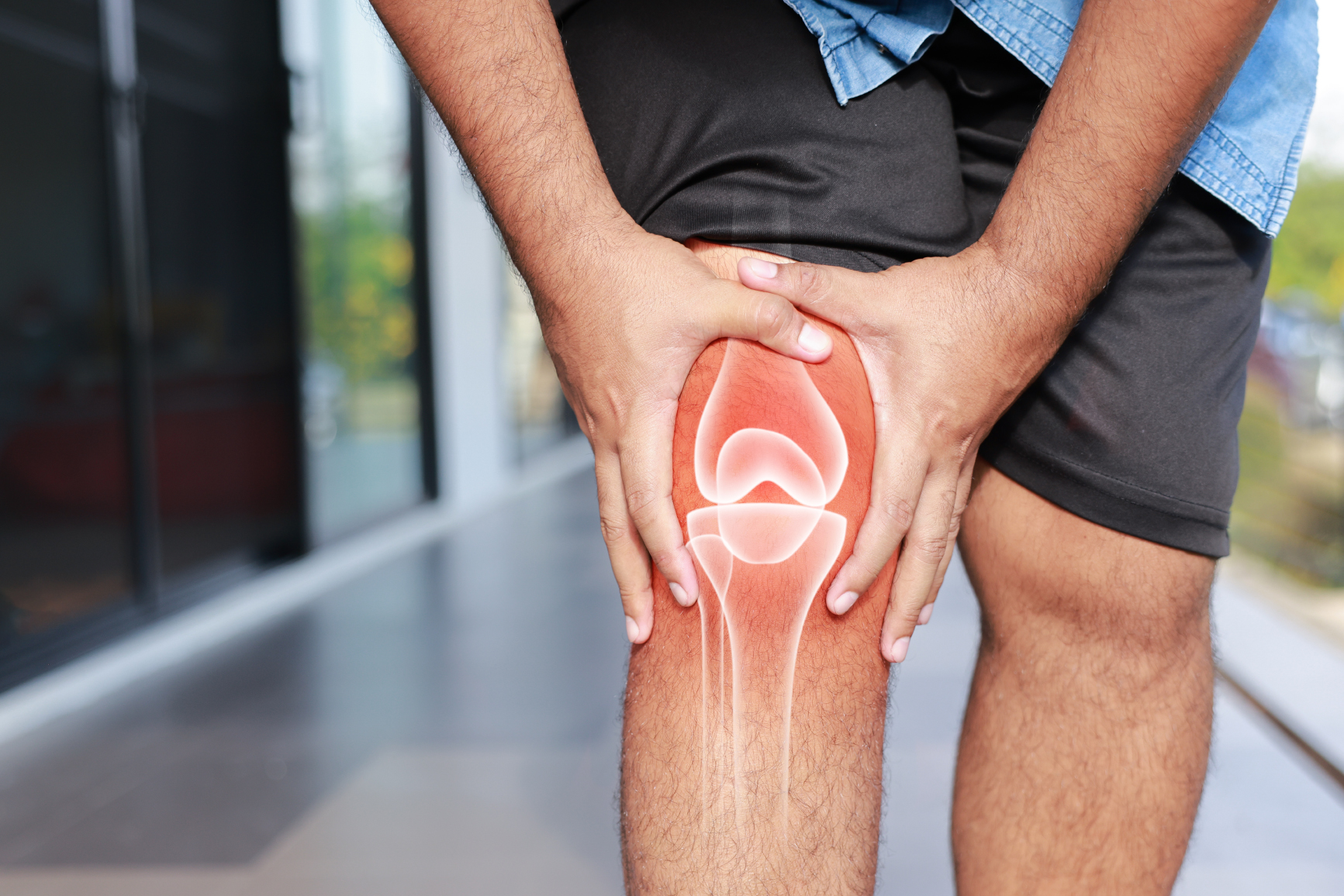 Man holding his knee experiencing joint pain