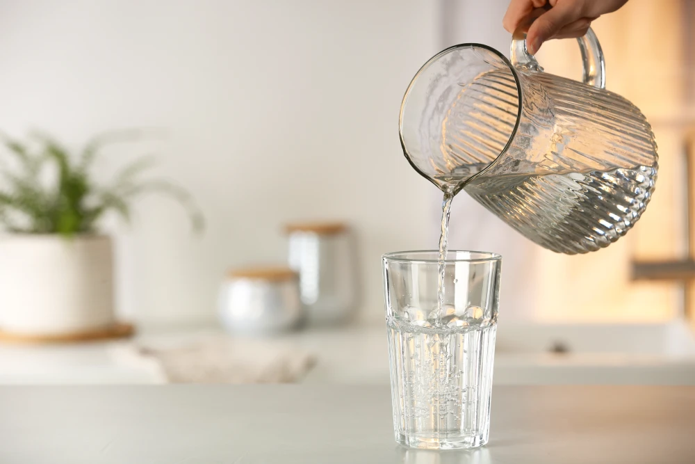 Water being poured from a jug into a glass.