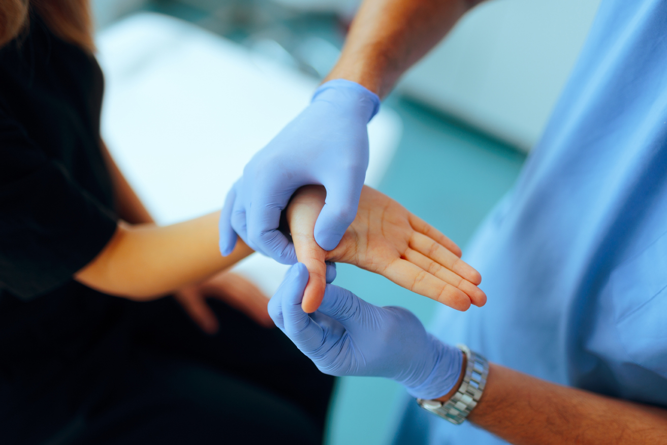 Rheumatoid arthritis doctor examining a patient's hand and wrist