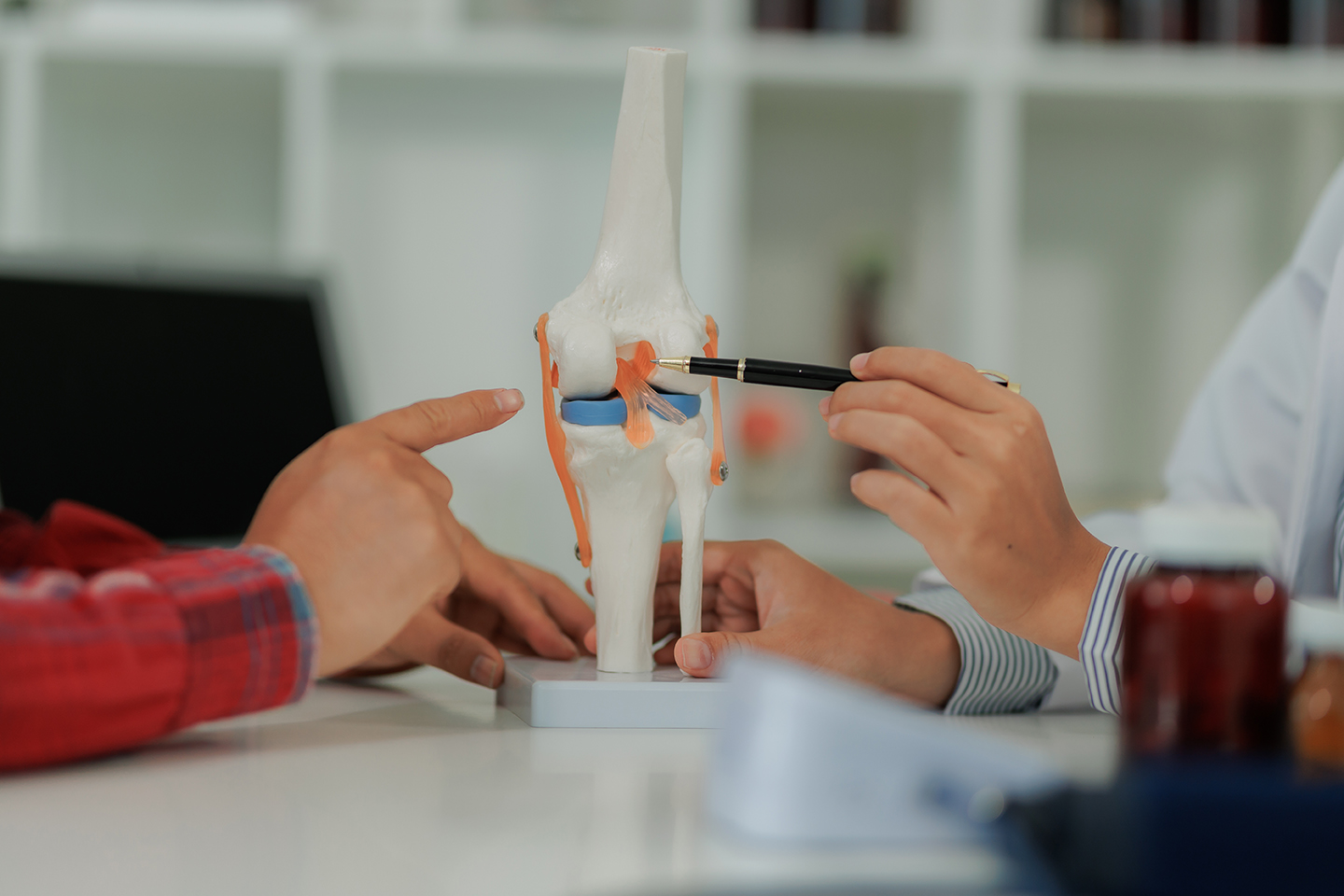 Patient discussing persistent joint pain and fatigue with a rheumatologist.